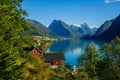 Beautiful Nature Norway natural landscape. Amazing red fishing house on fjord. Beautiful nature with blue sky