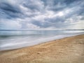 A beautiful splashing swash silky smooth water reflection on beach.