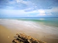 A beautiful splashing swash silky smooth water reflection on beach.