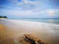 A beautiful splashing swash silky smooth water reflection on beach.