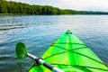 Beautiful nature scene on lake with green kayak.