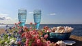 Beautiful nature vacation  romantic  summer  at sunset seascape two blue glasses of Champagne  living  coral blue white color wild Royalty Free Stock Photo