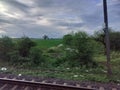 Beautiful nature view from Indian train. Dark cloudy sky Royalty Free Stock Photo