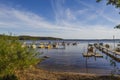 Beautiful nature water landscape view on summer day. Wooden boats parking on lake coast. Royalty Free Stock Photo