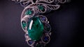 Beautiful necklace with blue sapphires and green emeralds on a black mannequin. Video. Close up of an expensive pendant Royalty Free Stock Photo