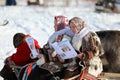 Beautiful Nenets girls in national clothes with a newspaper in the north of Siberia