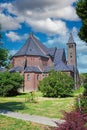 Beautiful neo gothic medieval St. Rochus church, green garden trees, now in use as Limburg archery museum - Steyl, Netherlands