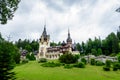 Beautiful neo-Renaissance building of Peles Castle Castelul Peles near Bucegi Mountains Muntii Bucegi in a cloudy summer day Royalty Free Stock Photo