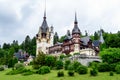 Beautiful neo-Renaissance building of Peles Castle Castelul Peles near Bucegi Mountains Muntii Bucegi in a cloudy summer day Royalty Free Stock Photo