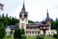 Beautiful neo-Renaissance building of Peles Castle Castelul Peles near Bucegi Mountains Muntii Bucegi in a cloudy summer day Royalty Free Stock Photo