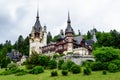 Beautiful neo-Renaissance building of Peles Castle Castelul Peles near Bucegi Mountains Muntii Bucegi in a cloudy summer day