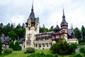 Beautiful neo-Renaissance building of Peles Castle Castelul Peles near Bucegi Mountains Muntii Bucegi in a cloudy summer day Royalty Free Stock Photo