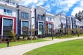 Beautiful new contempory suburban attached townhomes with colorful summer gardens in a Canadian neighborhood.