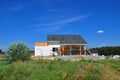 Beautiful New Cozy House Building Construction Exterior. Cozy house with Dormers, Skylights, Ventilation, Gutter, Drainage, Plaste Royalty Free Stock Photo