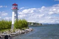 Beautiful new lighthouse beside a lake with a rocky shoreline