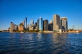 Beautiful New York City skyline from the water with sunlight hitting southern Manhattan