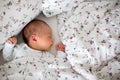 Beautiful newborn baby boy in bed. Infant lying down in bed. Healthy little kid shortly after birth Royalty Free Stock Photo