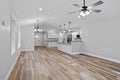 Beautiful newly renovated house corridor with hardwood floors and illuminated hanging lights