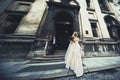 Beautiful newlywed couple posing near old church, elegant bride