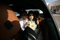 Beautiful newlyweds in the car Royalty Free Stock Photo