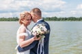 Beautiful newlyweds dancing by the lake hugged Royalty Free Stock Photo