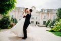 beautiful newlyweds dancing and whirling against the background of a building. Royalty Free Stock Photo