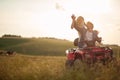 Beautiful newlyweds driving quad together Rural wedding concept