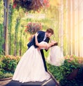 Beautiful newlyweds embrace in a green garden