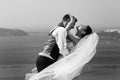 Beautiful newlyweds hugging on sea b