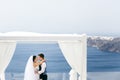 Beautiful newlyweds hugging on sea