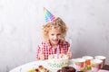 Beautiful nice girl with curly blond hair with forkes is ready to eat cake