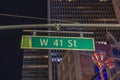 Beautiful night city view of tops of buildings and West 41st Street sign. New York. Royalty Free Stock Photo