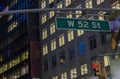 Beautiful night city view of tops of buildings and West 52st Street sign. New York. Royalty Free Stock Photo