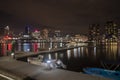 Colorful city lights and buildings by the docks at night