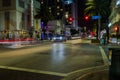 Beautiful night cityscape of Miami Beach street illuminated by lights of passing cars.