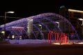 Beautiful night decorative lighting of the big arch near the modern building of the exhibition complex Expocentre Novosibirsk in