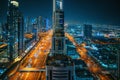 Beautiful night Dubai skyline downtown, United Arab Emirates. Aerial view from above of highways with car traffic and Royalty Free Stock Photo