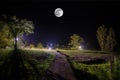 Beautiful night landscape of big full moon rising over the mountain road with hill and trees, mystical concept Royalty Free Stock Photo