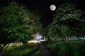 Beautiful night landscape of big full moon rising over the mountain road with hill and trees, mystical concept Royalty Free Stock Photo