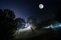 Beautiful night landscape of big full moon rising over the mountain road with hill and trees, mystical concept Royalty Free Stock Photo