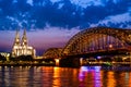 Beautiful night landscape of the Cologne, Germany with gothic cathedral, railway and pedestrian Hohenzollern Bridge and Royalty Free Stock Photo