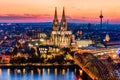 Beautiful night landscape of the gothic Cologne cathedral, Hohenzollern Bridge and the River Rhine at sunset and blue hour in Royalty Free Stock Photo