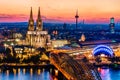 Beautiful night landscape of the gothic Cologne cathedral, Hohenzollern Bridge and the River Rhine at sunset and blue hour in Royalty Free Stock Photo