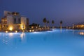 Beautiful night landscape overlooking hotel area with pool against dark sky. Royalty Free Stock Photo