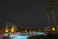 Beautiful night landscape view of hotel area. Lighting, trees, swimming pool modern buildings on dark sky background. Royalty Free Stock Photo