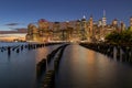 Beautiful Night Light and Lower Manhattan skyline with East River and New York City. Twilight with Reflections and Abandoned Pier Royalty Free Stock Photo