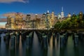 Beautiful Night Light and Lower Manhattan skyline with East River and New York City. Twilight with Reflections and Abandoned Pier Royalty Free Stock Photo