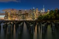 Beautiful Night Light and Lower Manhattan skyline with East River and New York City. Twilight with Reflections and Abandoned Pier Royalty Free Stock Photo