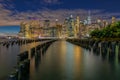 Beautiful Night Light and Lower Manhattan skyline with East River and New York City. Twilight with Reflections and Abandoned Pier Royalty Free Stock Photo