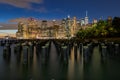 Beautiful Night Light and Lower Manhattan skyline with East River and New York City. Twilight with Reflections and Abandoned Pier Royalty Free Stock Photo